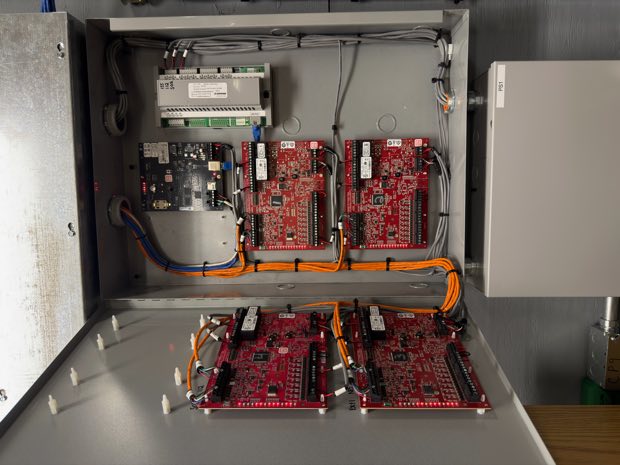 Flexible conduit entering an access control enclosure