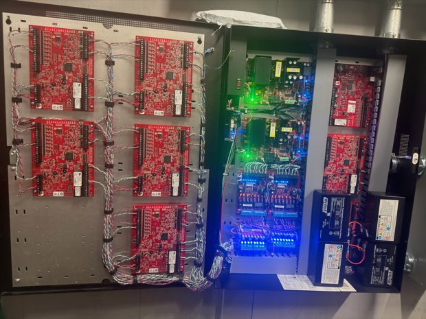 Array of access control boards inside a wall enclosure