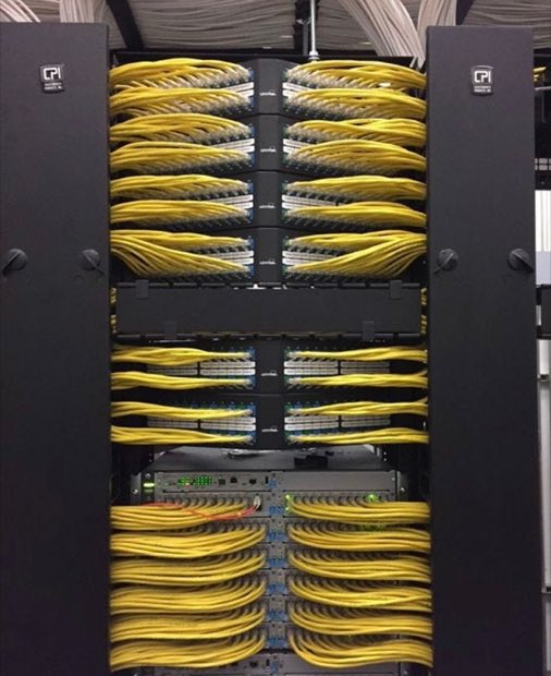 Yellow fiber patch cords terminated into a rack panel