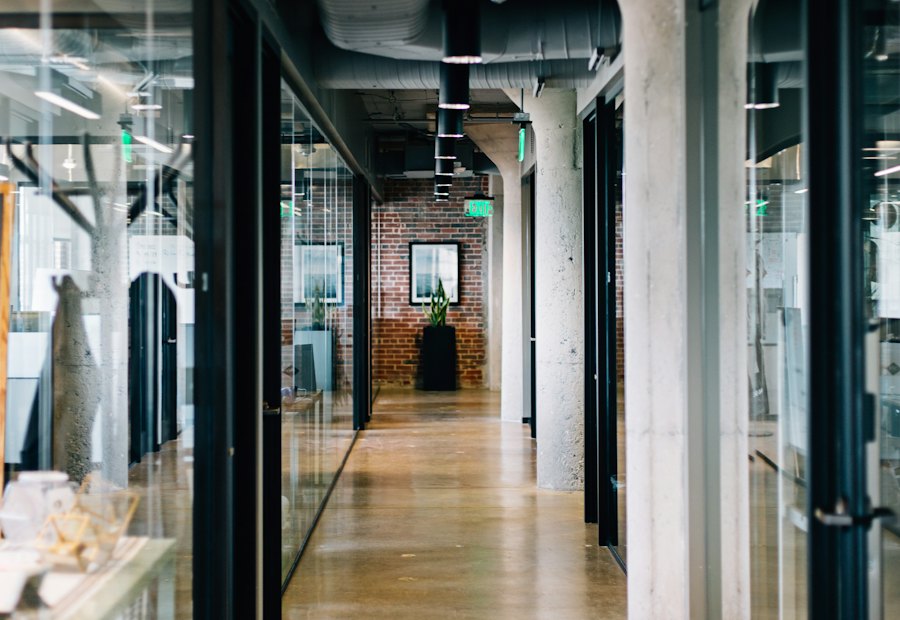 Institutional corridor with glass walls and concrete columns
